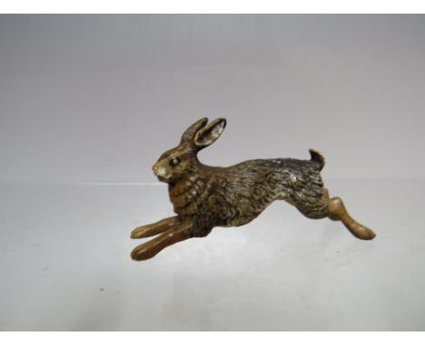 A SMALL COLD PAINTED BRONZE FIGURE OF A HARE, impressed mark 'Austria' to the underside, L 5 cm