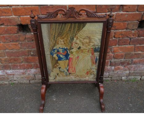 AN EARLY VICTORIAN MAHOGANY AND TAPESTRY EMBROIDERED FIRE SCREEN, the embroidered panel depicting a classical figural scene o