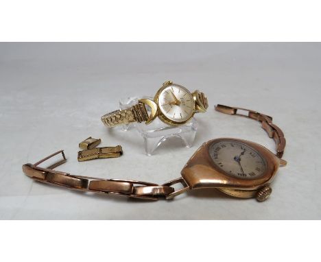 A LADIES 9 K GOLD CASED WRISTWATCH, on 9 ct gold expanding strap, A/F, together with an 18 K gold cased wristwatch with expan