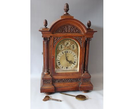 A LARGE CARVED OAK CASED BRACKET CLOCK BY WINTERHOLDER AND HOFMEIER, with a Westminster / Whittington gong strike movement, t