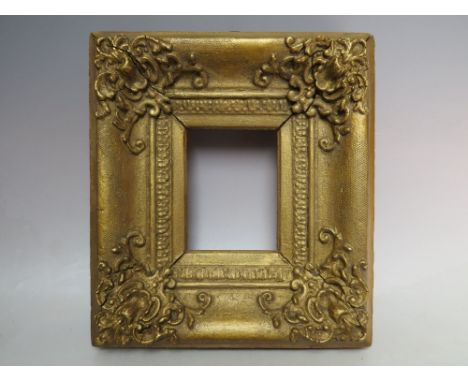 A 19TH CENTURY DECORATIVE GOLD PORTRAIT MINIATURE FRAME, with corner embellishments, width of frame 7 cm, rebate 14 x 9 cm