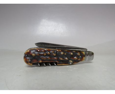 A LATE 19TH / EARLY 20TH CENTURY BONE HANDLED POCKET KNIFE, having four tools to include knife, corkscrew, etc., overall open