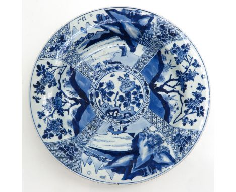 Alternating scenes of landscapes and flowers, marked on bottom with double ring and flower, 38 cm. in diameter, chip and hair