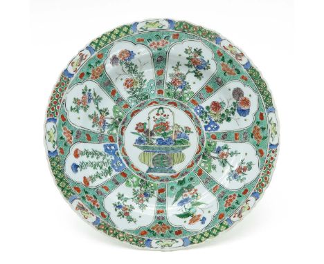 Fully decorated depicting alternating scenes of flowers on border, center of plate depicts flowers in basket with Chinese sym