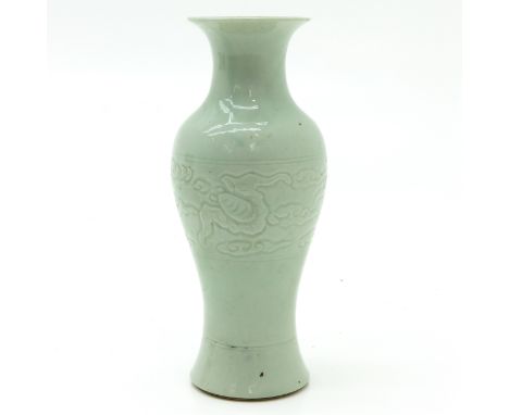 With incised dragon decor, marked on bottom with double ring, 21 cm. tall, fritting on edge.