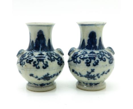 Floral decor, marked on bottom with double ring, 18 cm. tall, one restored.