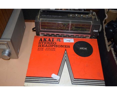 An Akai headphones box containing various leads  together with an Hitachi radio