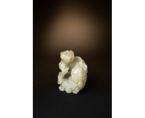 A RARE CHINESE CREAMY-WHITE JADE CHIMERASONG-MING DYNASTYThe chimera is strongly carved and seated on rockwork with its body 