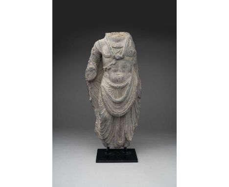 A GANDHARAN GREY SCHIST TORSO OF A BODHISATTVA2ND/3RD CENTURY ADCarved standing in a contrapposto stance, the bare chest abov