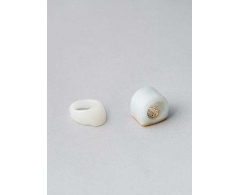 A CHINESE WHITE JADE ARCHER'S RING AND A JADEITE ARCHER'S RINGQING DYNASTYThe white jade ring of oval form with lateral shall