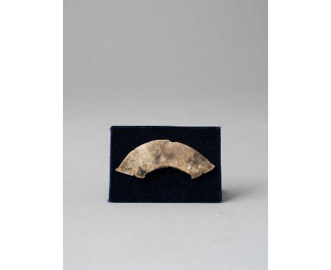 A CHINESE JADE FISH-FORM PENDANT WESTERN ZHOU DYNASTY  The fish pendant with its body tapering towards the notched tail, carv