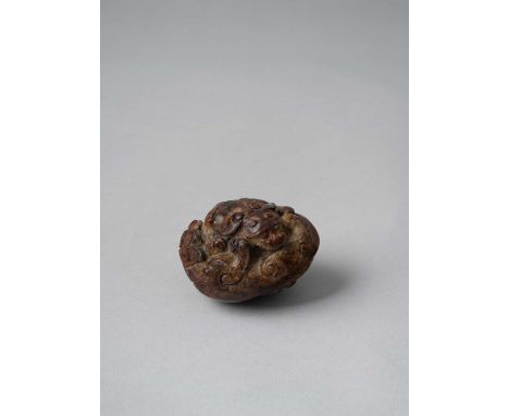 A CHINESE CARVED JADE GROUP OF TWO ENTWINED BUDDHIST LIONS SONG-MING DYNASTY  The boulder compactly carved to make maximum us