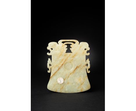 A CHINESE CELADON JADE BELL-SHAPED RITUAL PLAQUE, YUEMING/EARLY QING DYNASTYThe plaque carved on each side with a taotie mask