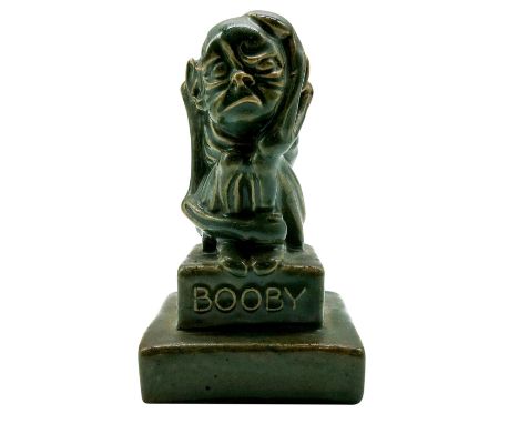 Very rare stoneware piece in green color; figure seated with one hand on his head on titled stepped base.Doulton Lambeth back