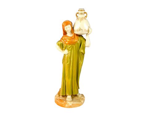 Beautiful porcelain figurine with alabaster colored body, green dress, and sienna colored headdress. Gold finish.Modeled as b