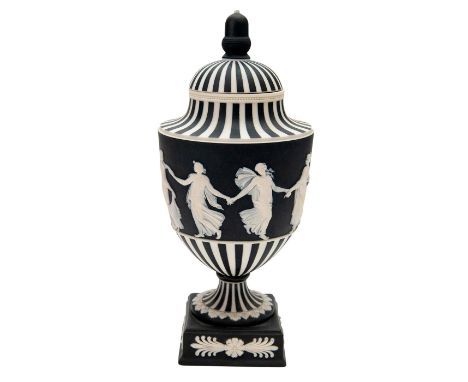 Model number 1202. Black and white, with engine turning and white interior. Depicts classically dressed women dancing in reli