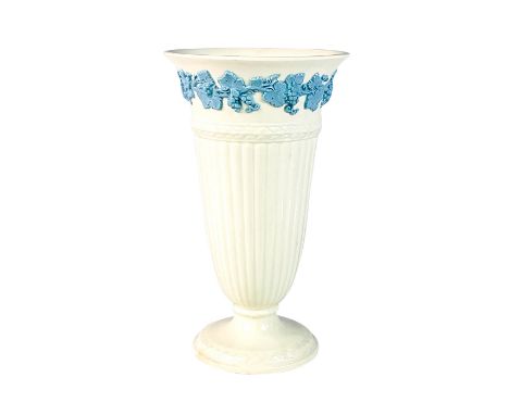 Lovely cream colored vase with raised grapevine motif in light blue.Dimensions: 6.5""H x 3.75""Dia.Manufacturer: WedgwoodCoun