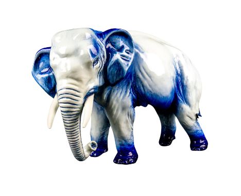 A stunning blue and white glaze majestic large elephant with a resting trunk.Artist: Charles NokeDimensions: 17.75"" L x 7.75