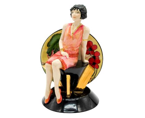 'Trilogy'.' Glossy hand painted figure of the ceramist, Clarice Cliff, in pink and gilded gold. She is seated on top of an Ar