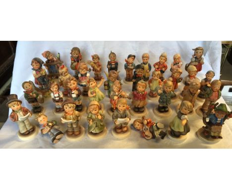 A collection of 35 small Hummel figurines.Condition ReportAll appear to be in a good condition. Some with minor paint loss.