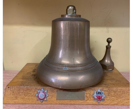 A brass fire engine bell with badges, East Riding Fire Brigade and Humberside Fire Brigade.
