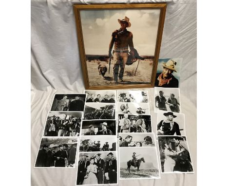 John Wayne framed poster print 67 x 56cms together with a collection of photo prints of scenes from his westerns.Condition Re