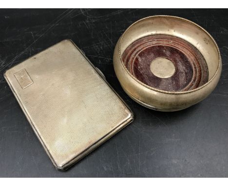 Hallmarked silver cigarette case, engine turned decoration M.H.M Birmingham 1939, 176gms and a silver coaster with mahogany b