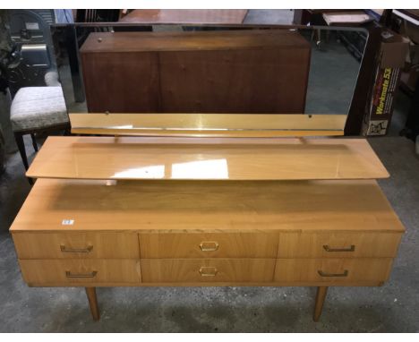 A retro teak Austinsuite dressing table with 6 drawers, shelf and mirror. 160 w x 43 d x 118cms h.Condition ReportChips and s