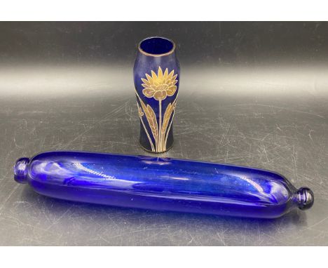 A 19thC Bristol blue glass rolling pin 37cms l together with a blue and gilt vase 16cms h.Condition ReportGood condition.