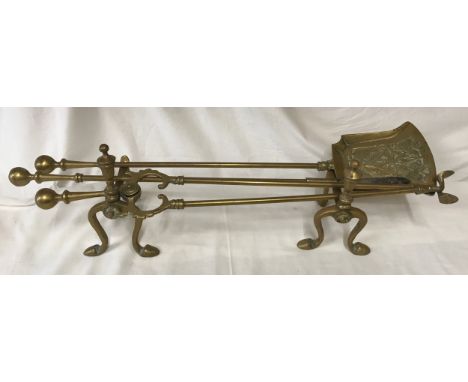 Brass fireside tools set of 3 on a pair of brass fire dogs, tools approx 67cms l.Condition ReportSigns of use with minor dent