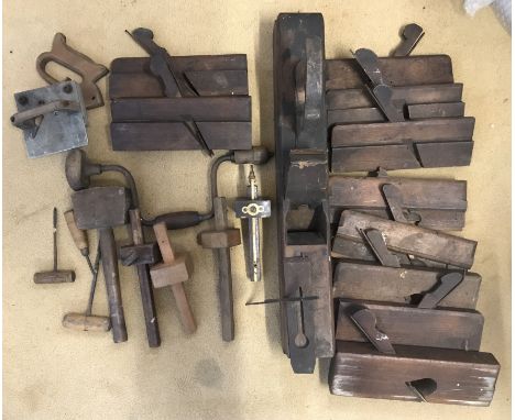 A selection of wooden carpentry tools to include various planes, scribes, etc.
