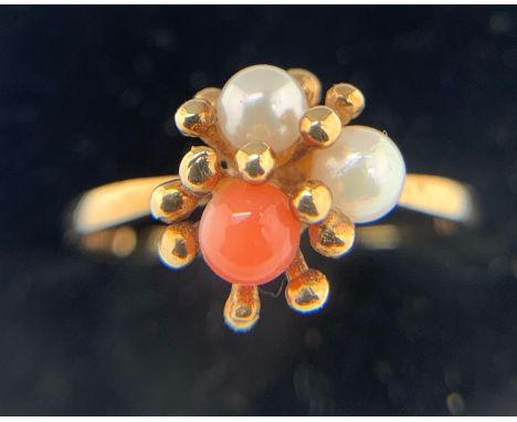 A seed pearl and coral ring set in 9ct yellow gold. Size N. With matching earrings. Total weight 4.3gms.Condition ReportGood 
