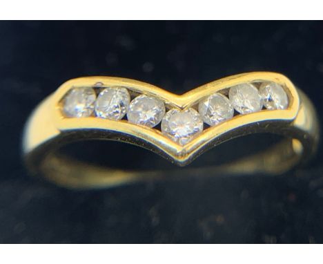 An 18ct yellow gold ring set with 7 diamonds in a V formation. Size P/Q, weight 2.9gms.