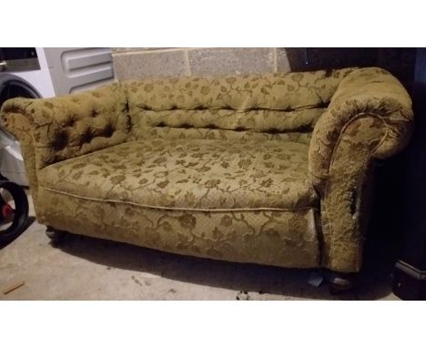 A  late Victorian drop end Chesterfield sofa on turned feet. 59cm x 150cm x 78cm.Worn original moquette covering.