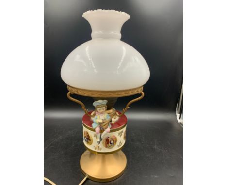 A vintage ceramic and glass table lamp with bisque figure.Condition ReportChip to toe of bisque figure, chips to glaze on bow