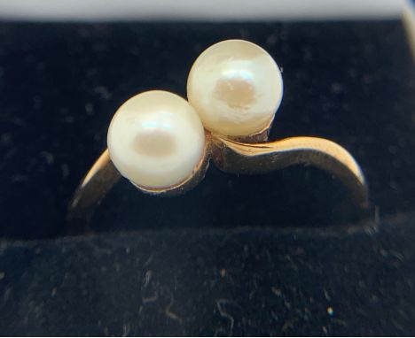 A 9ct yellow gold ring set with two cultured pearls. Size M. Weight 2.6gms.Condition ReportGood condition.