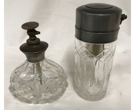 Two cut glass atomiser scent bottles, one sterling silver topped 11.5cms h and one pewter push button atomiser 13cms h.Condit