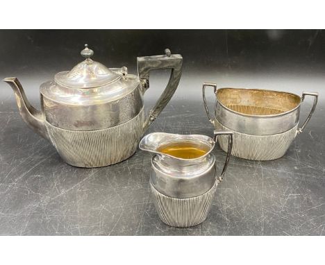 A hallmarked silver three piece tea set with half reeded body by James Dixon &amp; Sons, Sheffield. Various date marks. Teapo