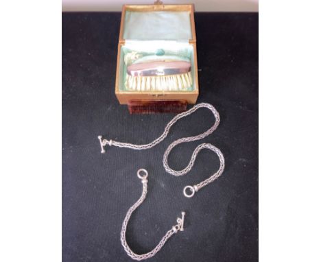 A chain necklace and matching bracelet marked .925 and a silver backed hair brush and comb in original case. Necklace and bra