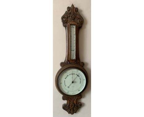 An early 20thc oak cased aneroid barometer with thermometer to stem. Proust Bros. Opticians Hull.Condition ReportGood conditi