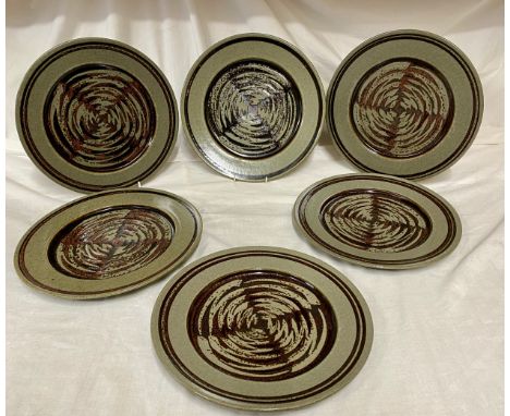 A collection of 6 David Lloyd Jones studio pottery dinner plates 29.5cms d with brown circular swirl pattern to centre.Condit