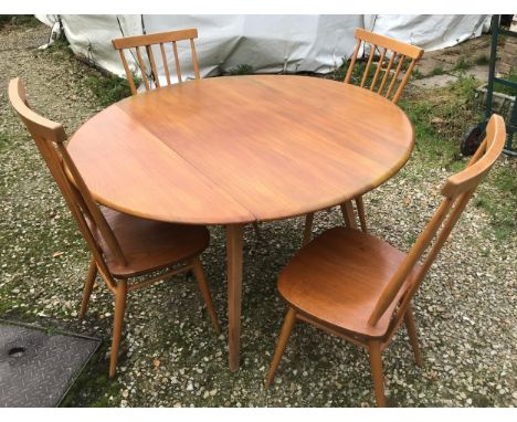 An Ercol oval drop leaf table with blue label. 113cm x 125cm open, 72cm h together with 4 stick back dining chairs, height to