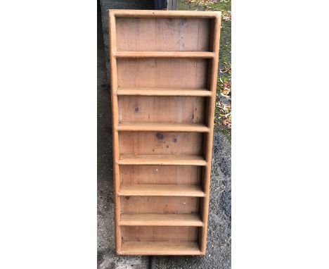 A wall mounted 7 height pine shelf, 99cms h x 39cms w x 8cms d.Condition ReportGood condition.