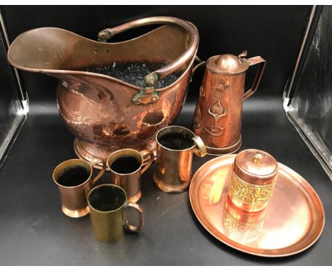 A selection of copperware to include a coal helmet 29cms h, Art Nouveau style jug 26cms h, tray, tobacco jar and four Victori