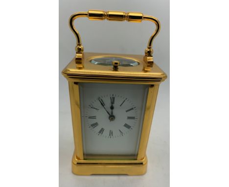 A brass cased carriage clock with repeater mechanism. 13cms h in leather protective case.Good condition.