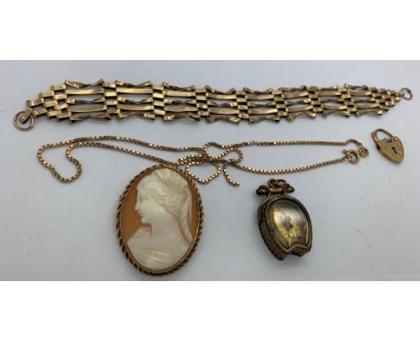 A 9ct gold gate bracelet, chain necklace and compass charm, total weight 26gms together with a shell cameo brooch in yellow m