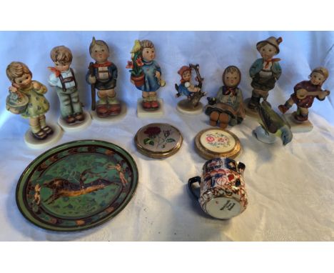 A mixed lot of 9 Hummel figurines. Tallest 14cms h. 2 compacts, small Imari jug, 6cms h and enamelled brass plate, bullfighte