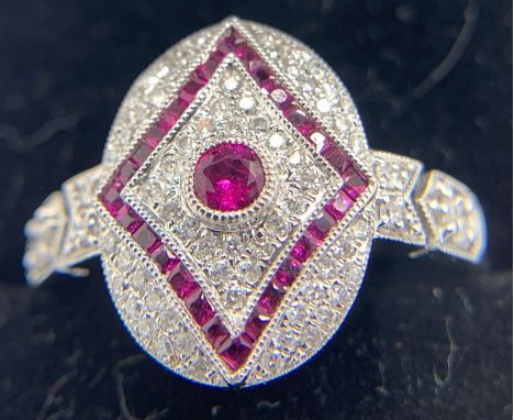 An 18ct white gold ring set with diamonds and rubies in an Art Deco style. Size O. Weight 4.1gms.Condition ReportGood conditi