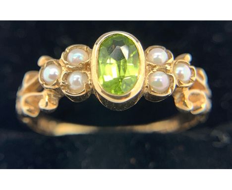 A peridot and seed pearl ring set in 9ct yellow gold. Size N. Weight 2.4gms.Condition ReportSlight wear to shank.