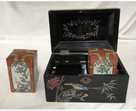 A Chinese black lacquer tea caddy with intricate colourful mother of pearl inlay of birds, fans and floral designs. Inside is